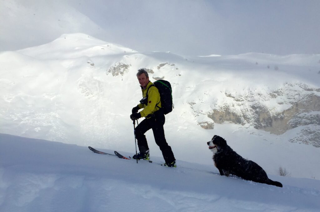 person and dog in snow