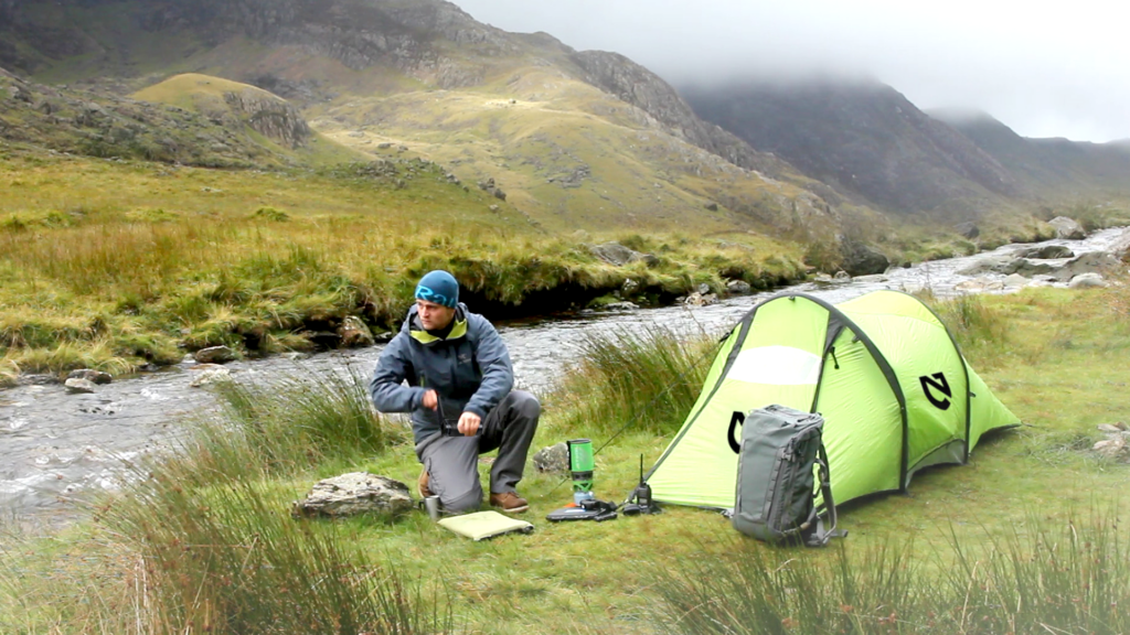 tent and person using Emergency Power Hand Crank